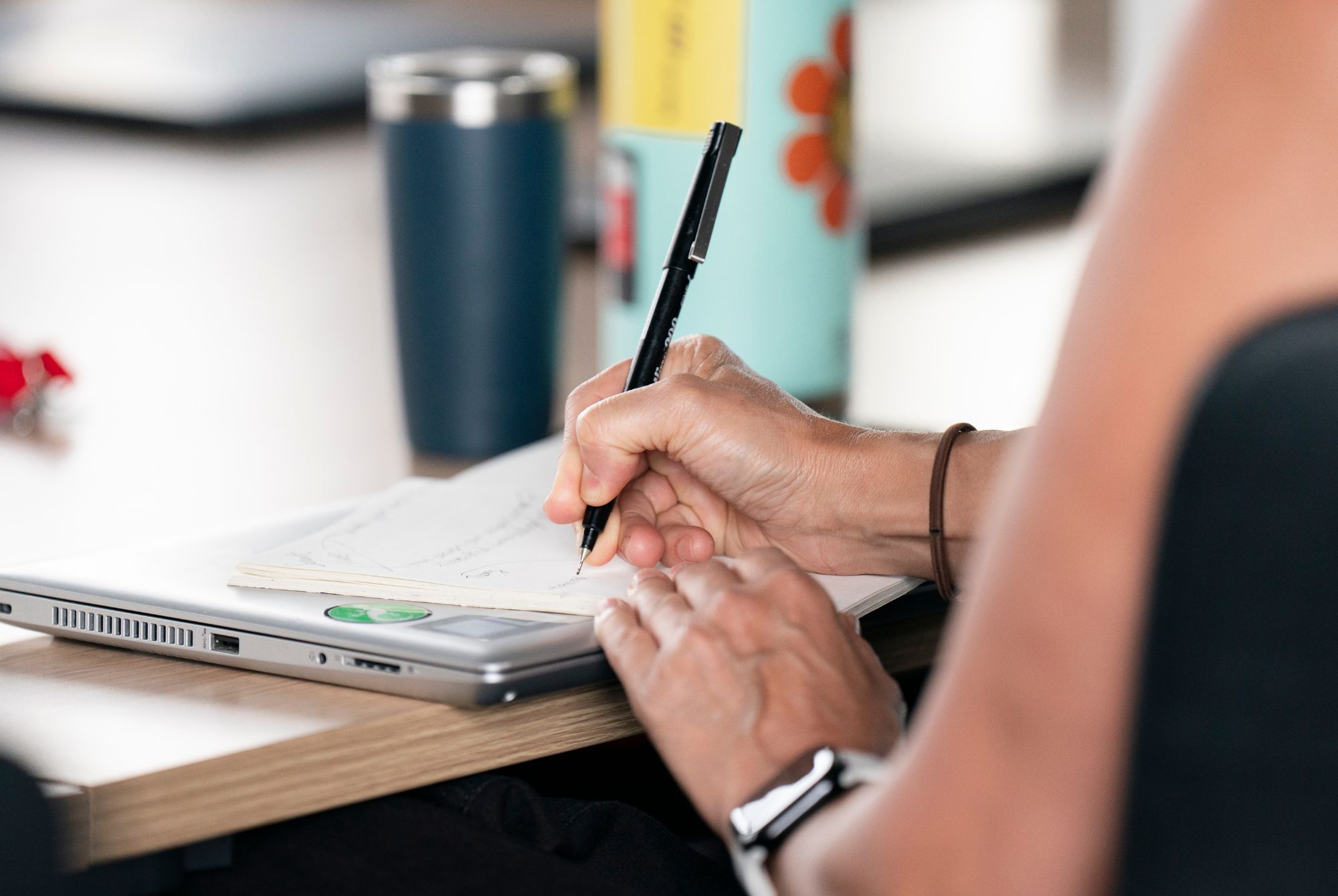 A student writing at a desk